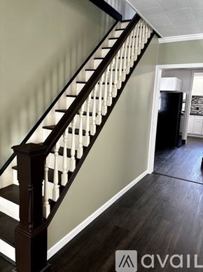 Schuylkill Haven house for rent - A staircase with a dark wood banister and white balusters.