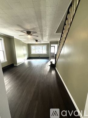 Schuylkill Haven house for rent - A long hallway with wood floors and a ceiling fan.