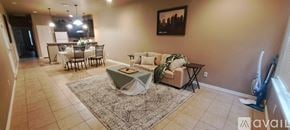 Three Rivers townhouse for rent - A living room with a couch, chair, and a dining table.