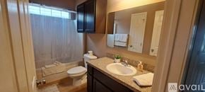 Three Rivers townhouse for rent - A bathroom with a toilet, sink, and mirror.