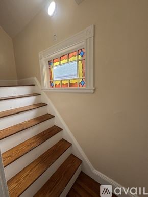 Boston house for rent - A living room with a couch, a chair, a coffee table, and a ceiling fan.