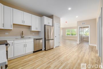 Carol Stream apartment for rent - A kitchen with white cabinets and a refrigerator.