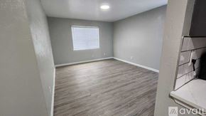 Dallas apartment for rent - A room with wooden flooring and a window with blinds.