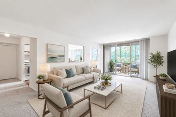 Scranton apartment for rent - A living room with a white sofa, a coffee table, and a painting on the wall.
