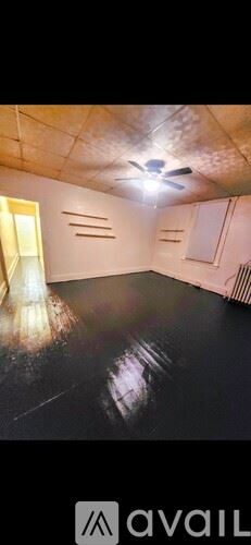Johnstown townhouse for rent - A red brick house with a white fence and a staircase leading to the second floor.