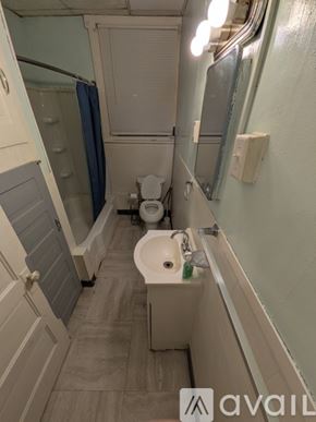 Johnstown townhouse for rent - A bathroom with a toilet, sink, and mirror.