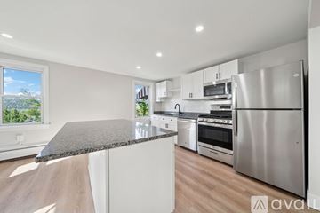 Sewickley apartment for rent - A living room with a grey couch and a wooden coffee table.