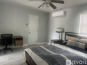 Bradenton apartment for rent - A bedroom with a bed, desk, and chair.
