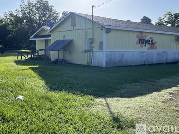 Arnaudville house for rent - A white building with a sign that says "raye's" on it.