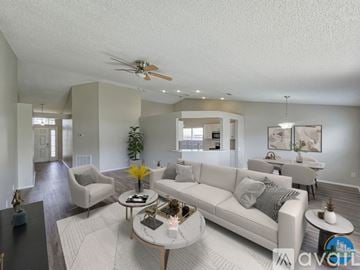 Riverview house for rent - A spacious living room with a white sofa set and a coffee table.