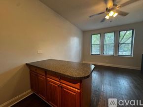 Chicago apartment for rent - A room with a counter and a ceiling fan.