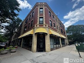 Chicago apartment for rent - A building with a red brick facade and a yellow awning.