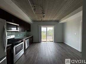 Chicago apartment for rent - A kitchen with dark brown cabinets and a white counter.