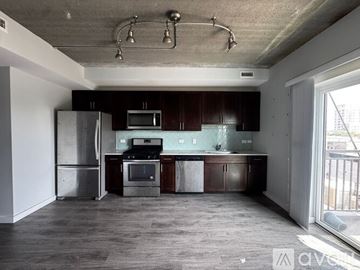 Chicago apartment for rent - A living room with a grey couch and a black and white rug.