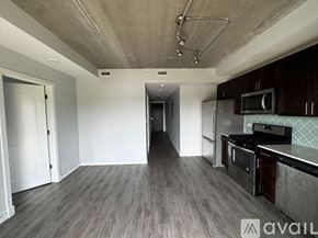 Chicago apartment for rent - A bedroom with a large bed and a wooden floor.
