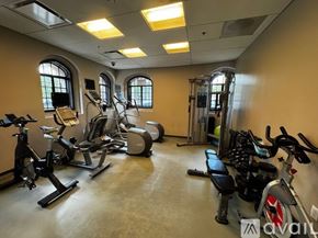 Chicago apartment for rent - A gym with a variety of exercise equipment including treadmills, stationary bikes, and weight machines.