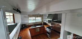 Sausalito house for rent - A kitchen with wooden floors and stainless steel appliances.
