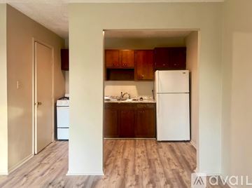 Owensboro apartment for rent - A kitchen with wooden cabinets and a white refrigerator.