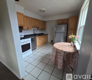Milwaukie house for rent - A kitchen with a table and a refrigerator.