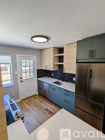 Denver house for rent - A kitchen with a stove top oven and a refrigerator.