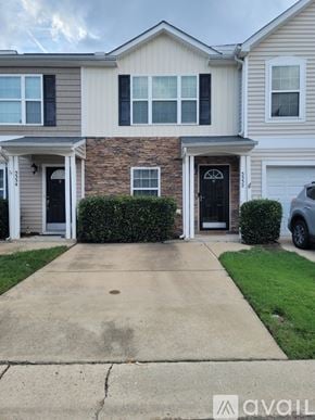 Raleigh townhouse for rent - A house with a stone wall and a black door.