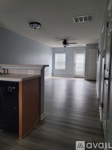 Raleigh townhouse for rent - A kitchen with a black oven and wooden cabinets.