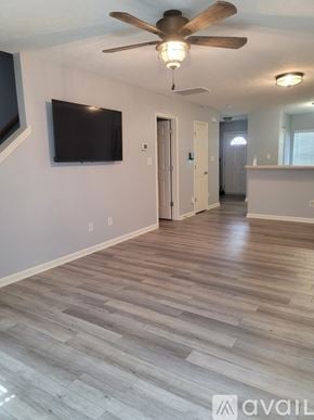 Raleigh townhouse for rent - A living room with a flat screen TV mounted on the wall.