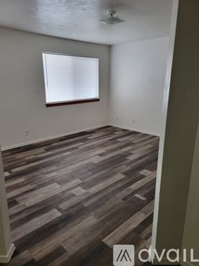 Idaho Falls apartment for rent - A room with wooden flooring and a window with blinds.