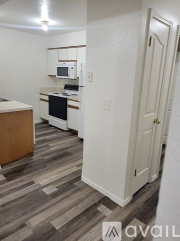 Idaho Falls apartment for rent - A kitchen with a microwave, oven, and cabinets.