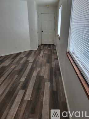 Idaho Falls apartment for rent - A hallway with wooden flooring and a white door.