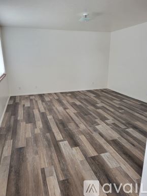 Idaho Falls apartment for rent - A room with wooden flooring and a ceiling fan.