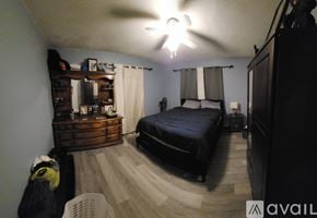 Mesick apartment for rent - A bedroom with a bed, dresser, and ceiling fan.