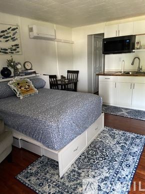 Broadalbin apartment for rent - A bedroom with a bed, chair, and a television.
