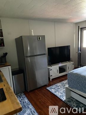 Broadalbin apartment for rent - A kitchen with a refrigerator, a television, and a bed.
