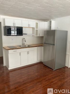 Broadalbin apartment for rent - A kitchen with white cabinets and a wooden countertop.