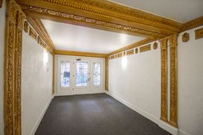 San Francisco apartment for rent - A room with a white wall and a doorway with a glass window.