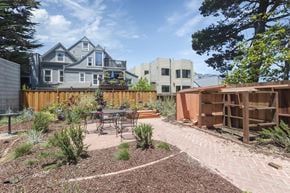 San Francisco apartment for rent - A backyard with a table and chairs surrounded by a wooden fence.