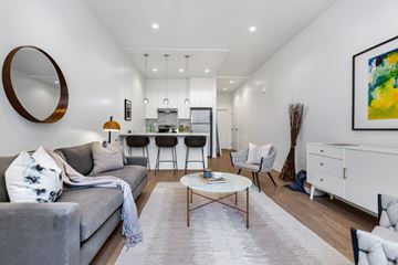 San Francisco apartment for rent - A modern living room with a grey sofa and a coffee table.