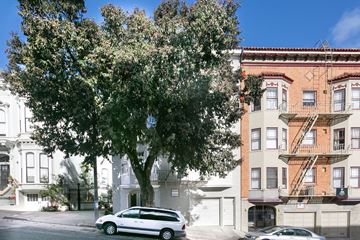 San Francisco apartment for rent - A tree in front of a building with a car parked in front of it.