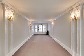 San Francisco apartment for rent - A long hallway with white walls and a carpeted floor.