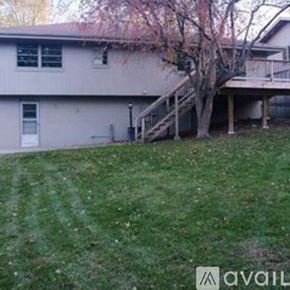 Omaha house for rent - A house with a tree in front of it.