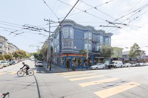 San Francisco apartment for rent - A street scene with a cyclist on the road and a tram overhead.
