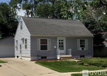 Cedar Rapids house for rent - A small house with a grey roof and white siding is for sale.