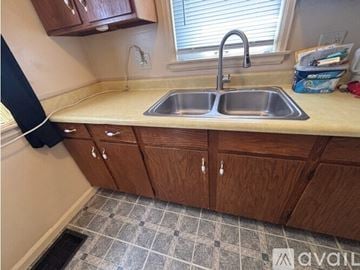 Cedar Rapids house for rent - A kitchen with a sink and cabinets.