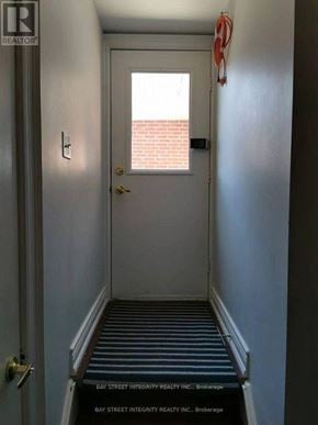 Markham (Unionville) house for rent - A hallway with a door and a sign that says Bay Street Integrity Realty Inc. Brokerage.