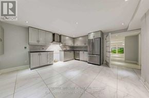 Markham (Unionville) house for rent - A spacious kitchen with stainless steel appliances and white cabinetry.