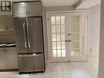 Markham (Unionville) house for rent - A kitchen with a stainless steel refrigerator and a white door.
