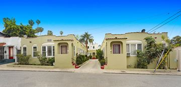 Los Angeles apartment for rent - A row of houses with green exteriors and red doors.