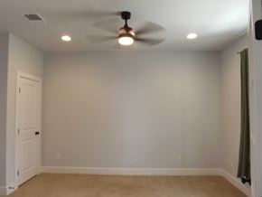 Granite Shoals house for rent - A room with a ceiling fan and a door.