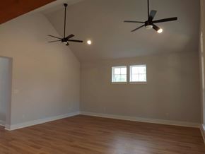 Granite Shoals house for rent - A room with wooden floors and a ceiling fan with two lights.